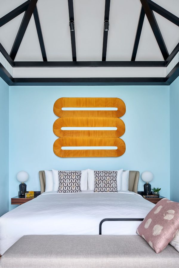 Khem Beach Resort — bedroom with woven wall art